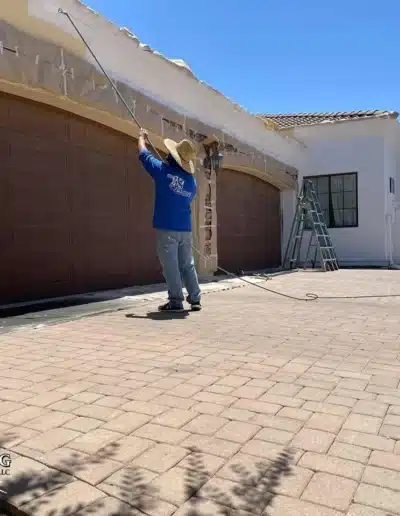 roller painting exterior of residence